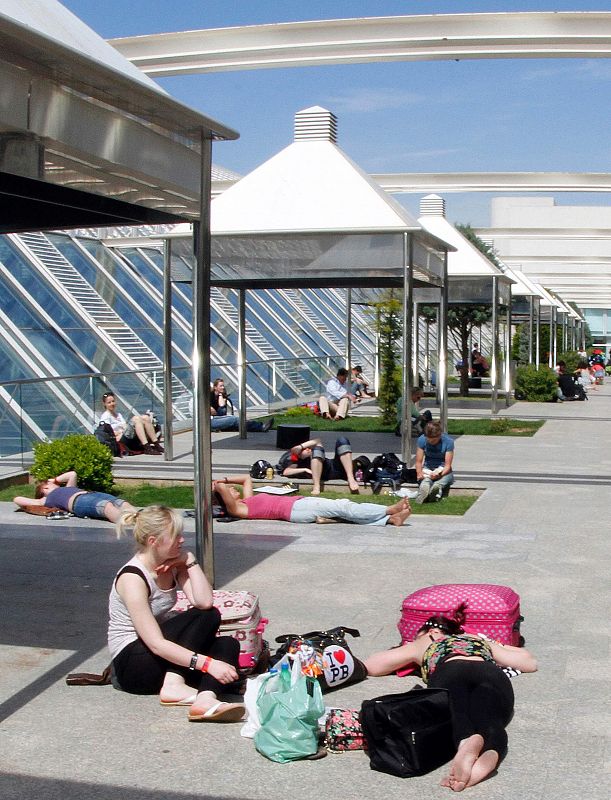 Sranded travellers soak up the sun as they wait in Mallorca airport