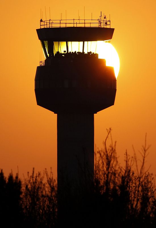 The sun sets behind the air traffic control tower at East Midlands Airport