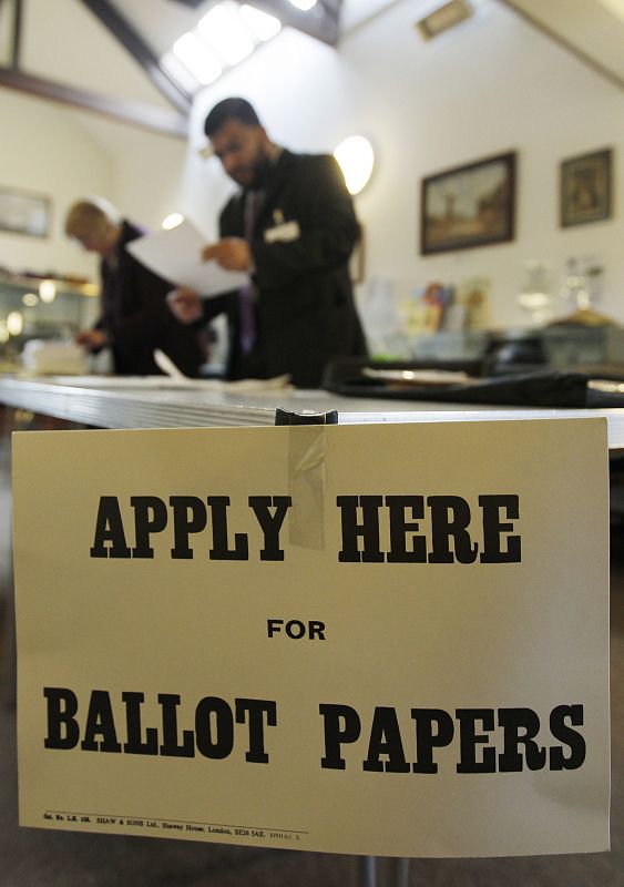 Presiding electoral officer and team prepare papers in a polling station at West Blatchington Windmill before voting began in the general election at West Blatchington in Brighton