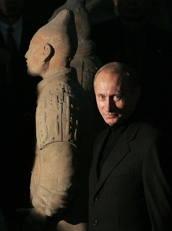 Russian President Vladimir Putin passes by the life-sized sculptures of warriors in Xi'an.