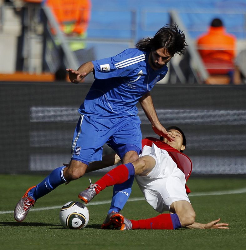 Greece's Giorgos Samaras  fights for the ball with South Korea's Kim Jung-woo during a 2010 World Cup Group B soccer match