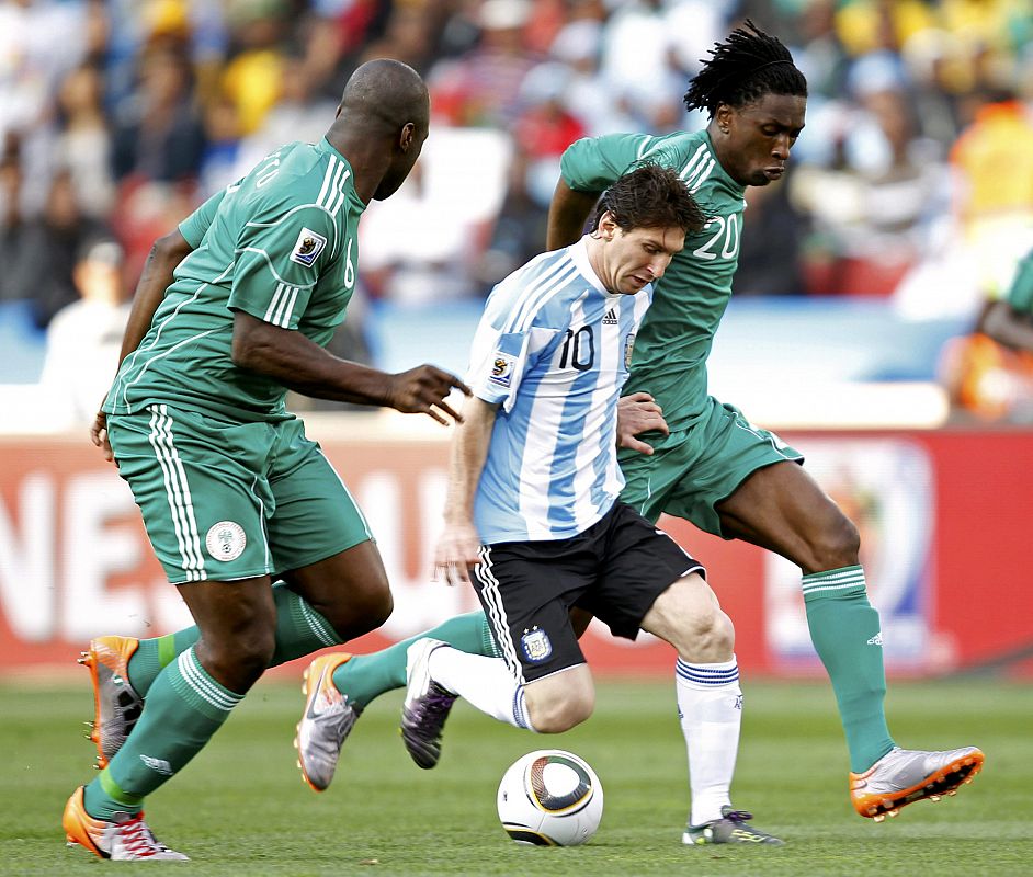 Argentina's Messi fights for the ball with Nigeria's Etuhu during a 2010 World Cup Group B soccer match at Ellis Park stadium in Johannesburg