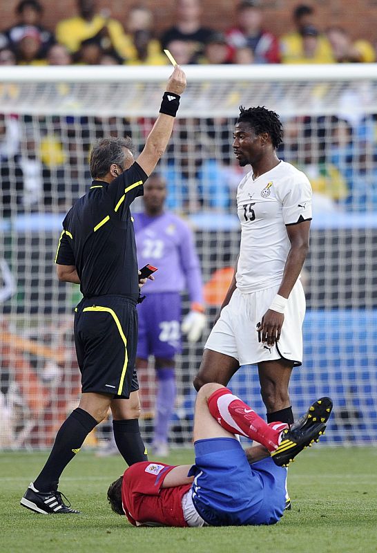 Ghana's Isaac Vorsah receives a yellow card from referee Hector Baldassi of Argentina during a 2010 World Cup Group D soccer match