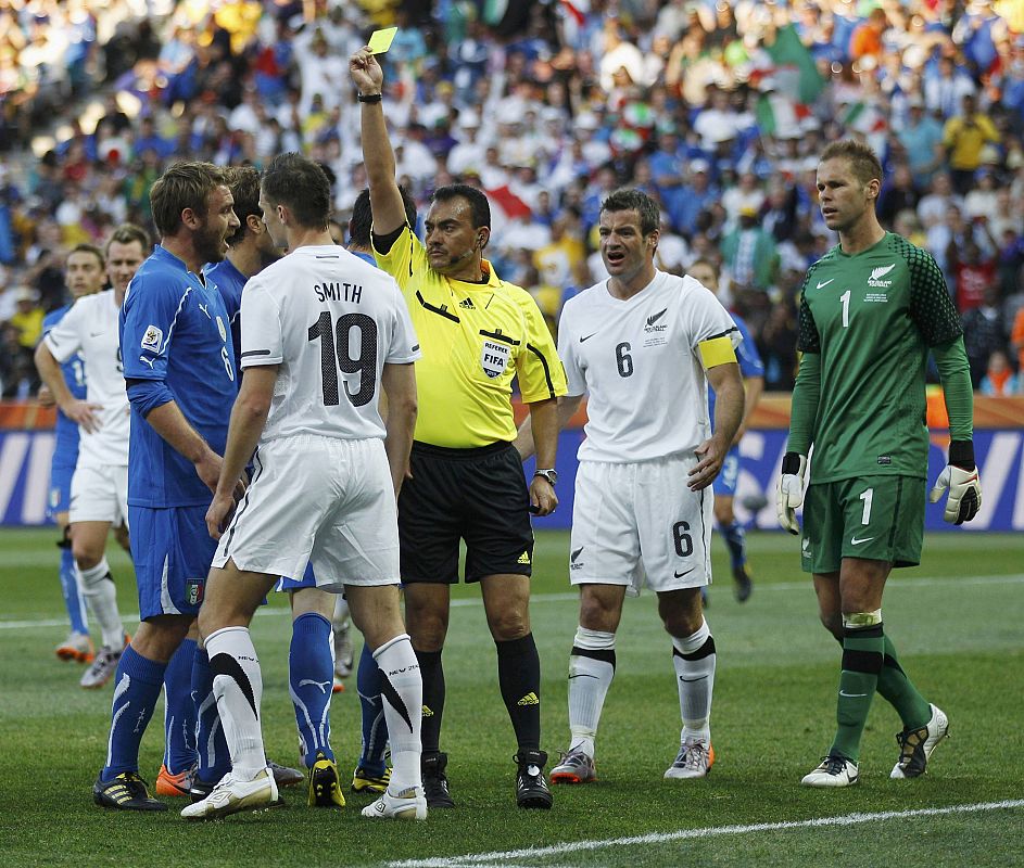 Italy's Daniele De Rossi falls to the ground after a faul by New Zealand's Tommy Smith during their 2010 World Cup Group F soccer match at Mbombela stadium in Nelspruit