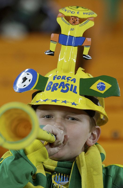 A fan blows the vuvuzela before the 2010 World Cup Group G soccer match between Brazil and Ivory Coast at Soccer City stadium in Johannesburg