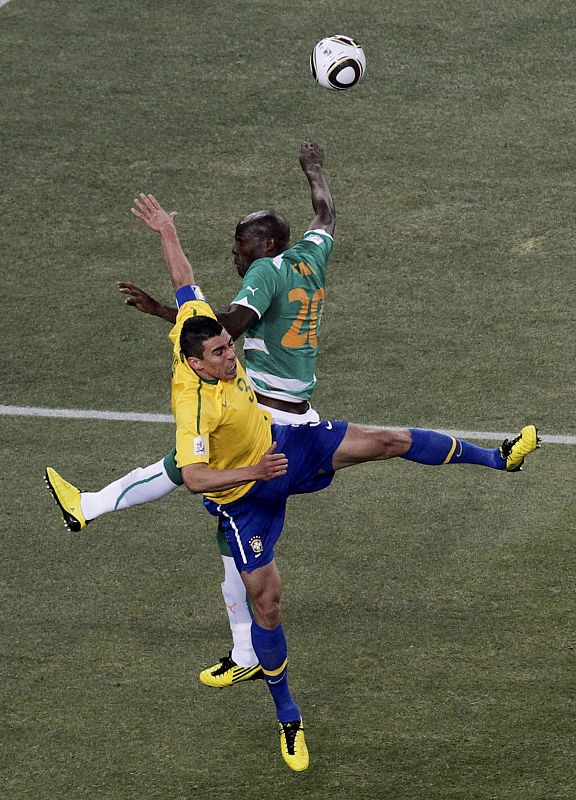 Ivory Coast's Demel fights for the ball with Brazil's Lucio during a 2010 World Cup Group G soccer match at Soccer City stadium in Johannesburg