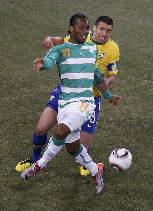 Ivory Coast's  Didier Drogba (11) and Brazil's Lucio fight for the ball during a  2010 World Cup Group G soccer match at Soccer City stadium in Johannesburg