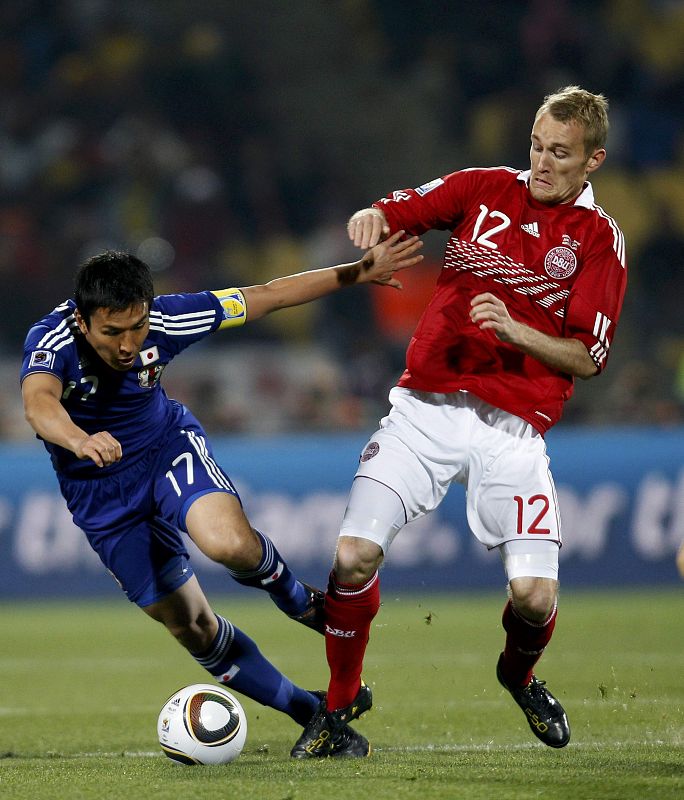 Denmark's Kahlenberg fights for the ball with Japan's Hasebe during a 2010 World Cup Group E soccer match at Royal Bafokeng stadium in Rustenburg