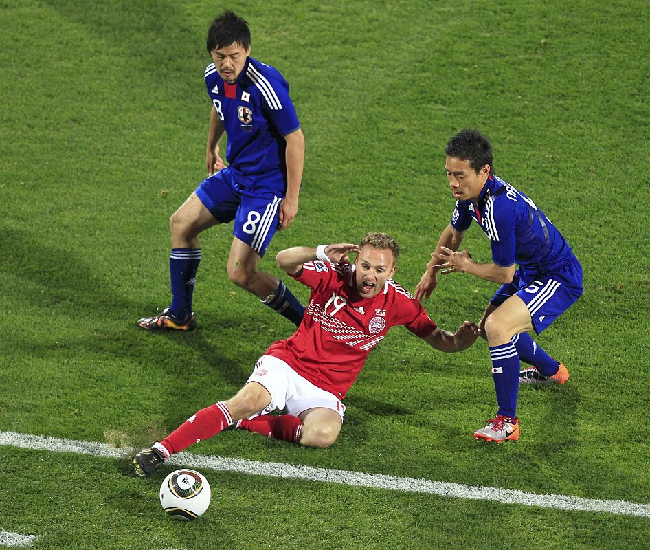 Denmark's Rommedahl fights for the ball with Japan's Nagatomo during a 2010 World Cup Group E soccer match at Royal Bafokeng stadium in Rustenburg