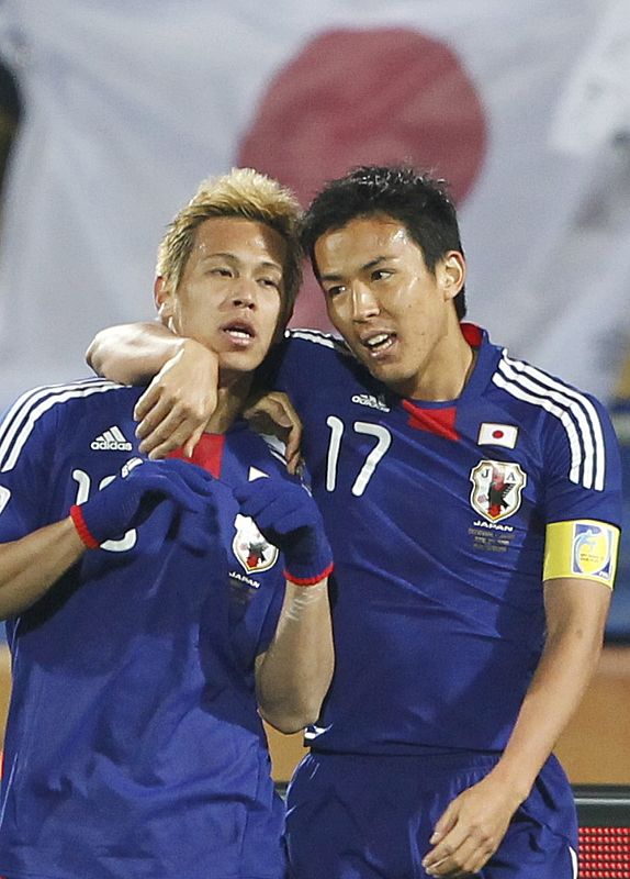 Japan's Keisuke Honda celebrates his goal with Makoto Hasebe (R) during their 2010 World Cup Group E soccer match against Denmark at Royal Bafokeng stadium in Rustenburg