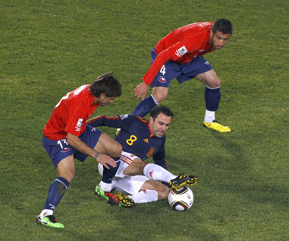 Chile's Marco Estrada and teammate Mauricio Isla fight for the ball with Spain's Xavi during a 2010 World Cup Group H match at Loftus Versfeld stadium