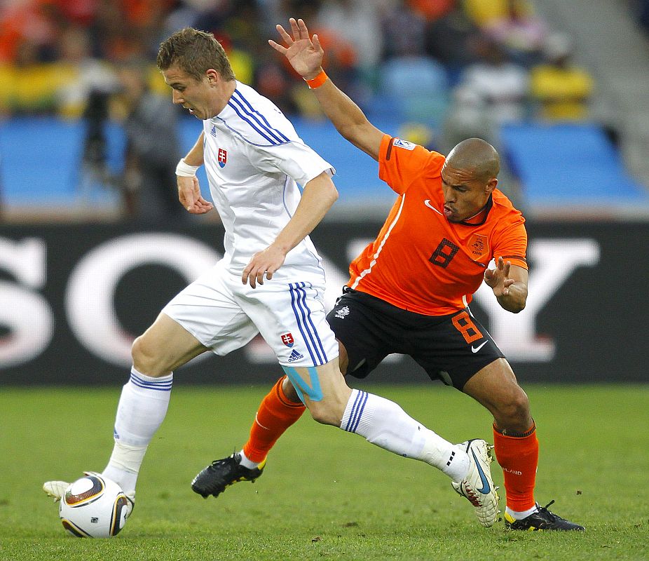 El holandés Nigel de Jong lucha por el balón con el eslovaco Juraj Kucka durante el partido que ha metido a Holanda en cuartos de final del Mundial de Sudáfrica.