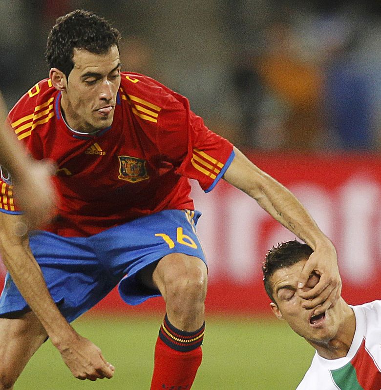 Spain's Busquets grabs the face of Portugal's Ronaldo during the 2010 World Cup second round soccer match at Green Point stadium in Cape Town