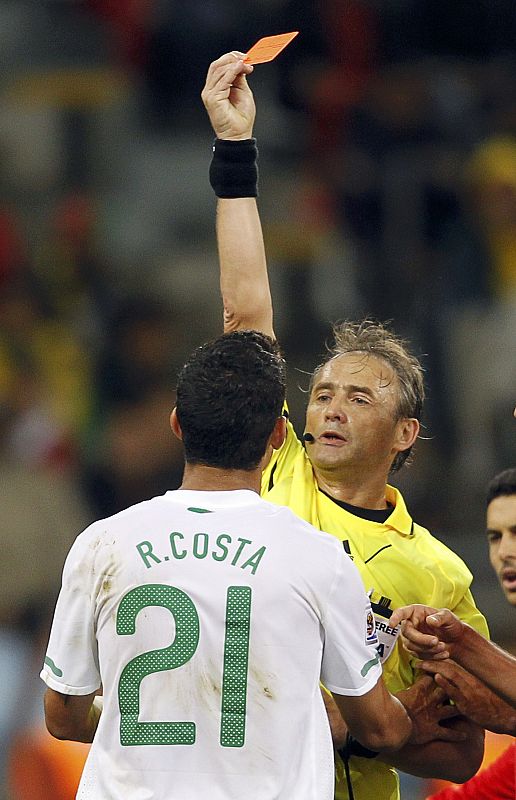 Referee Baldassi shows the red card to Portugal's Costa during the 2010 World Cup second round soccer match against Spain in Cape Town