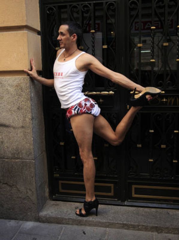 Man stretches before the annual race on high heels during EuroPride celebrations, in the quarter of Chueca in Madrid