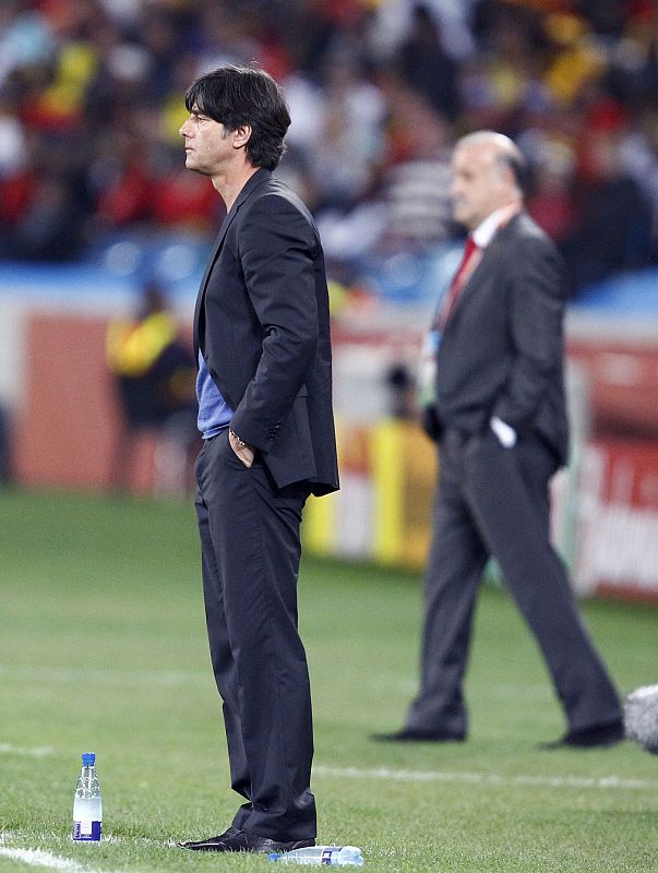 Germany's coach Joachim Loew watches the match as Spain's coach Vicente del Bosque stands near him in Durban