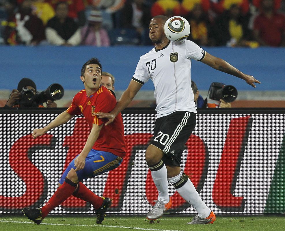 Germany's Jerome Boateng fights for the ball with Spain's David Villa during their 2010 World Cup semi-final soccer match at Moses Mabhida stadium in Durban