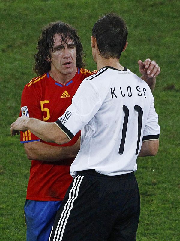 Spain's Puyol greets Germany's Klose at the end of their 2010 World Cup semi-final soccer match in Durban