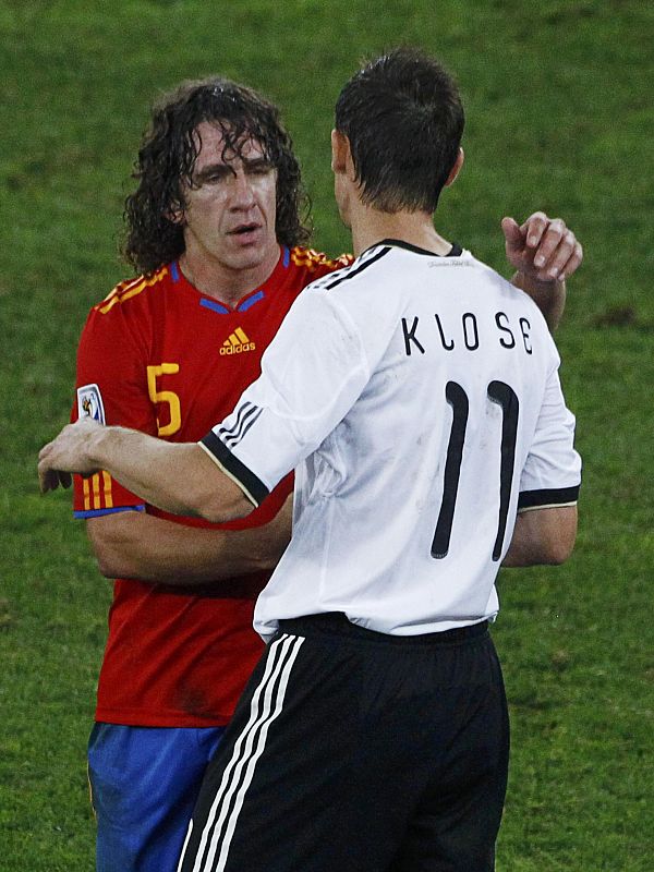 Spain's Puyol greets Germany's Klose at the end of their 2010 World Cup semi-final soccer match in Durban