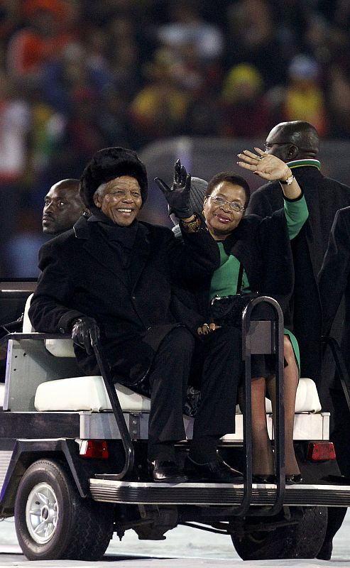 Former South African President Mandela and his wife wave to crowd at Soccer City stadium during closing ceremony for 2010 World Cup in Johannesburg