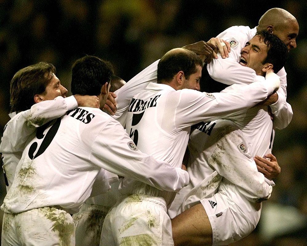 Real Madrid's star Raul Gonzalez (R) is congratulated by his team mates, including Brazilian Roberto..