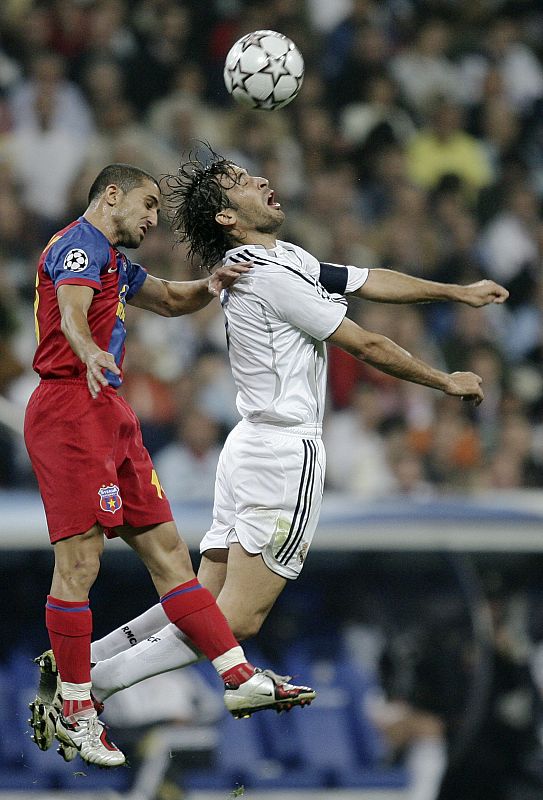 Real Madrid's Raul Gonzalez jumps for ball with Steaua Bucharest's Petre Marin during Champions League match in Madrid