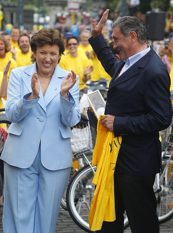 French Sports and Health Minister Roselyne Bachelot-Narquin jokes with former Belgian cycling champion Eddy Merckx before the start of the second stage of the Tour de France cycling race from Brussels to Spa