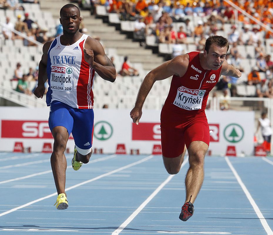 Poland's Krynski crosses the finish line ahead of France's Mbandjock during their men's 200 metres heats at the European Athletics Championships in Barcelona