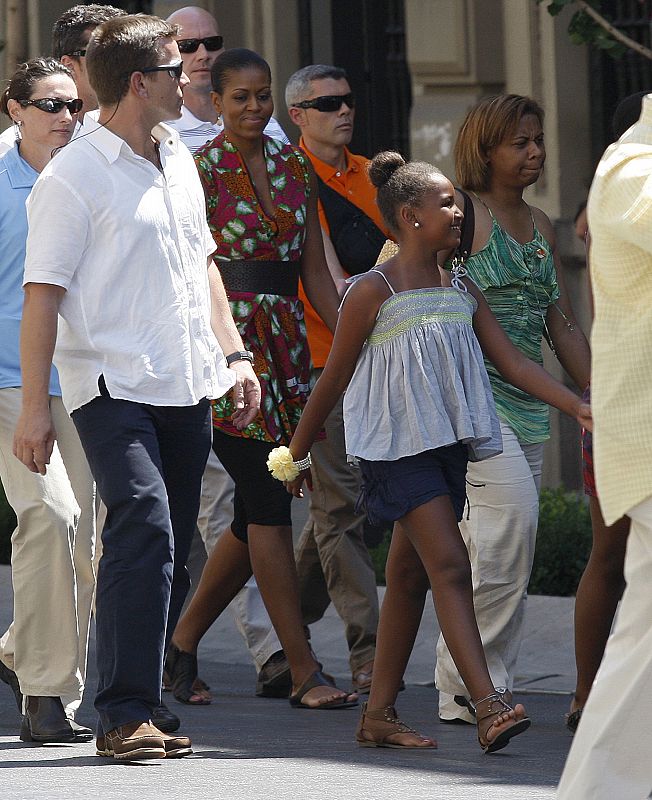 U.S. first lady Michelle Obama walks through the streets during her vacation with her daughter Sasha to the historic center of the southern Spanish town of Granada