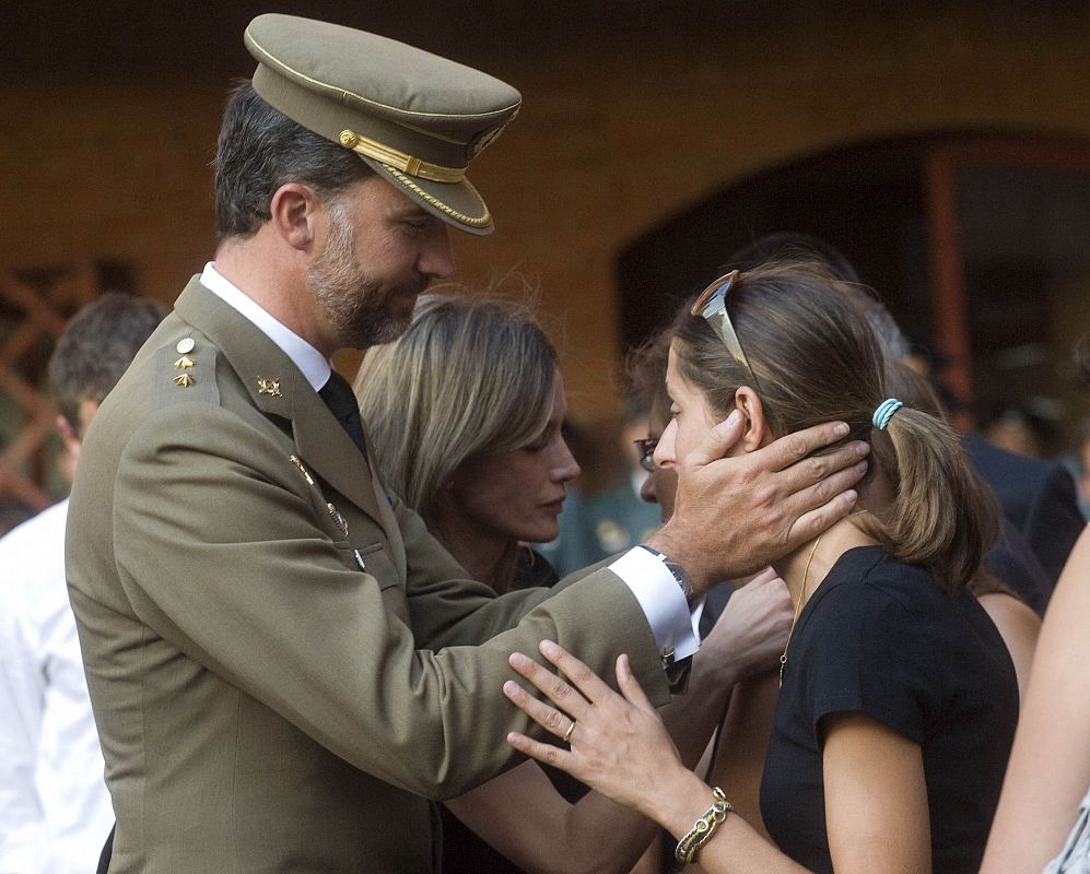 Spain's Prince Felipe consoles a relative of one of the two Spanish Civil Guards who were killed in Afghanistan during a funeral ceremony at their barracks in Logrono
