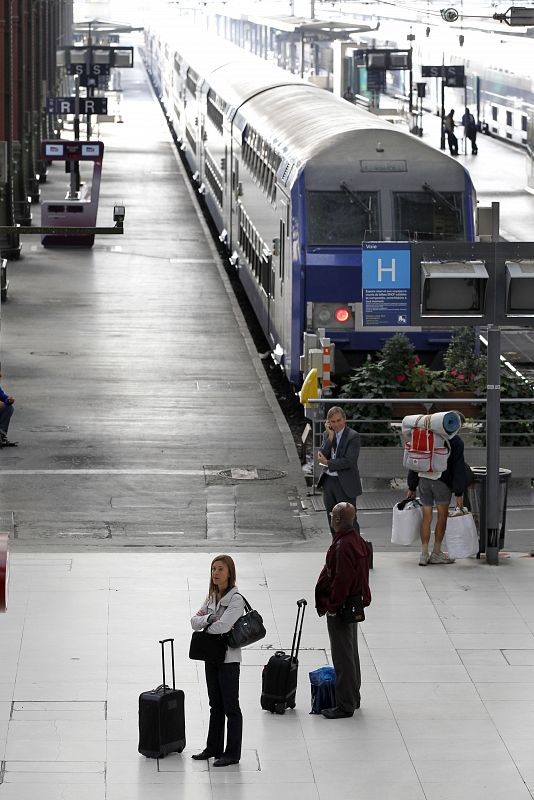 People wait for a train at the Gare de Lyon railway station in Paris