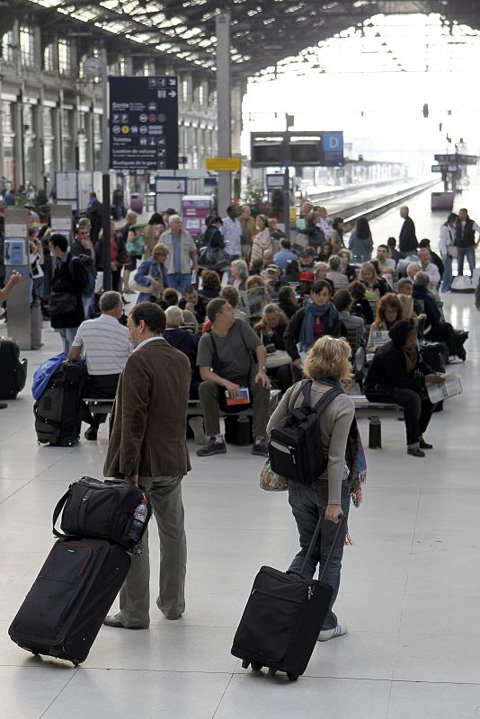 People wait for a train at the Gare de Lyon railway station in Paris