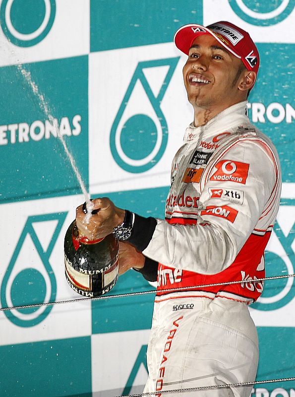 McLaren Formula One driver Hamilton of Britain sprays champagne as he celebrates on the podium after the South Korean F1 Grand Prix at the Korea International Circuit in Yeongam