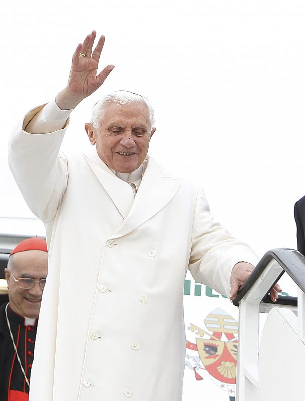 El papa Benedicto XVI saluda a su llegada al aeropuerto de Lavacolla.