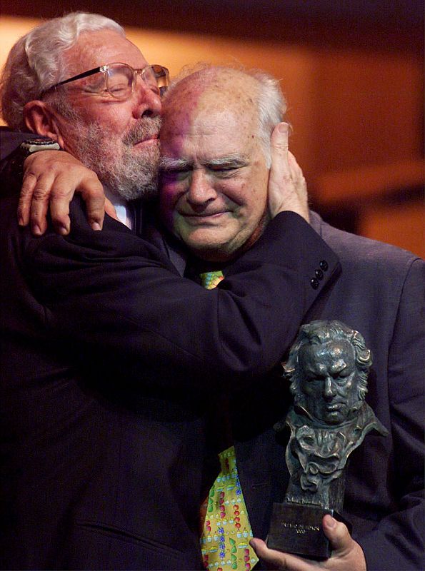 Director Isasi-Isasmendi (R) embraces Jose Luis Berlanga (L) after he received a Goya prize during t..