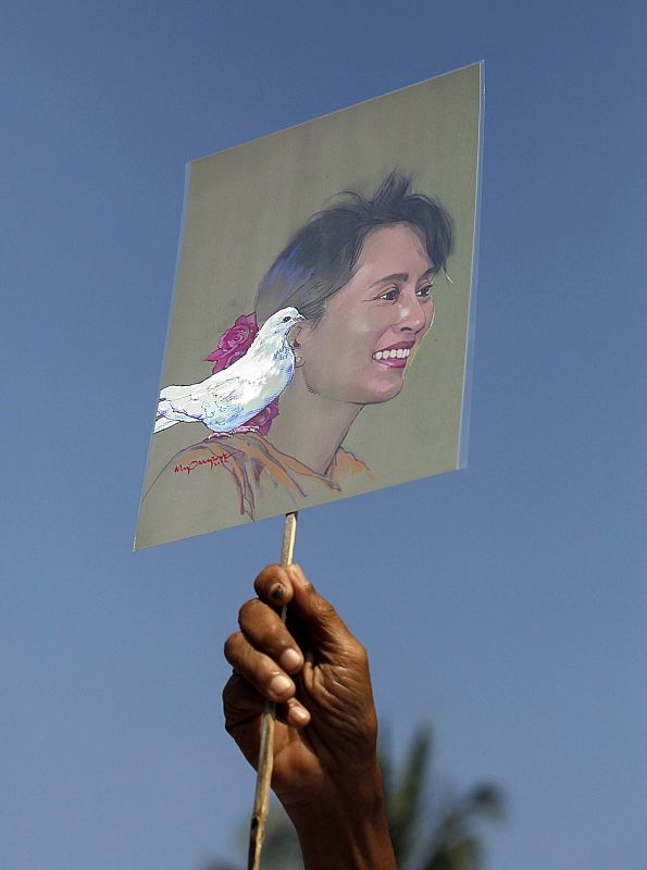 A member of the National League for Democracy holds a sketch of Nobel Peace laureate Aung San Suu Kyi during a protest demanding her release from house arrest in Yangon