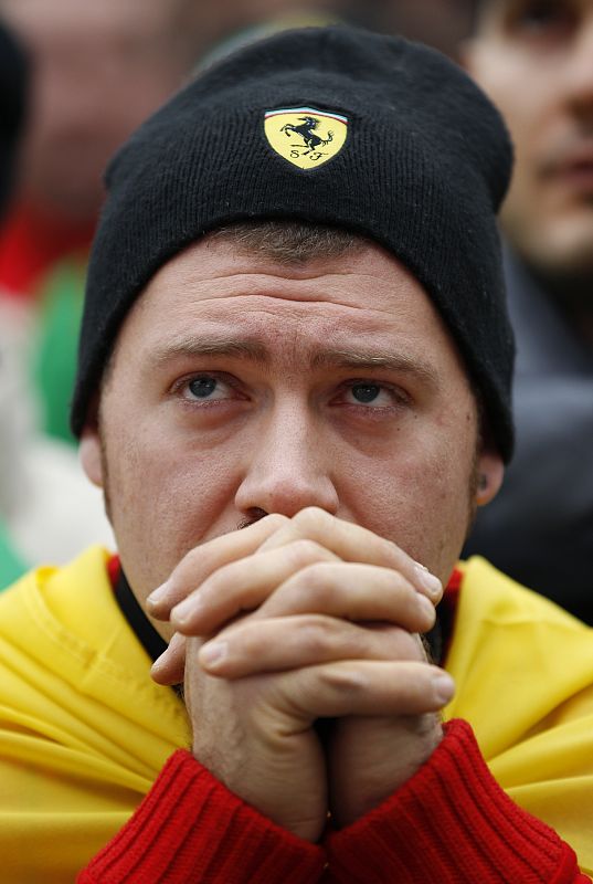 A Ferrari supporter reacts as he watches the Abu Dhabi F1 Grand Prix at Yas Marina circuit on a giant screen in Maranello