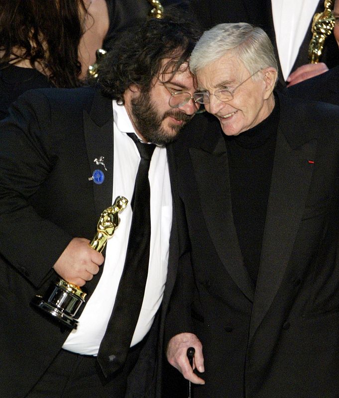 DIRECTOR PETER JACKSON EMBRACES BLAKE EDWARDS AT THE CLOSE OF ACADEMY AWARDS.