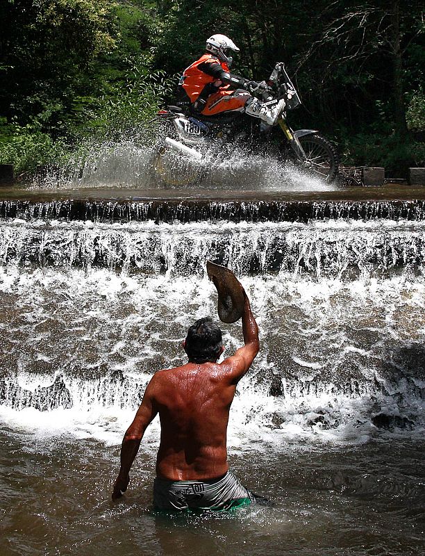 A spectator greets KTM pilot Emanuel Sulem of France during the first stage of the third South American edition of the Dakar Rally 2011 from Victoria to Cordoba