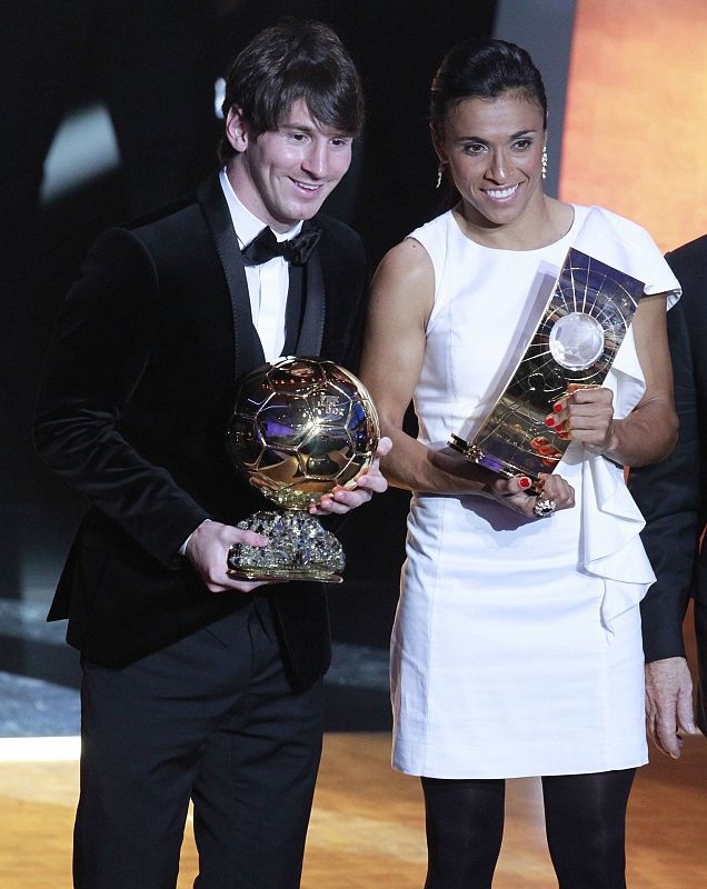 Messi of Argentina and Marta of Brazil hold their World Player 2010 trophies during the FIFA Ballon d'Or 2010 soccer awards ceremony in Zurich