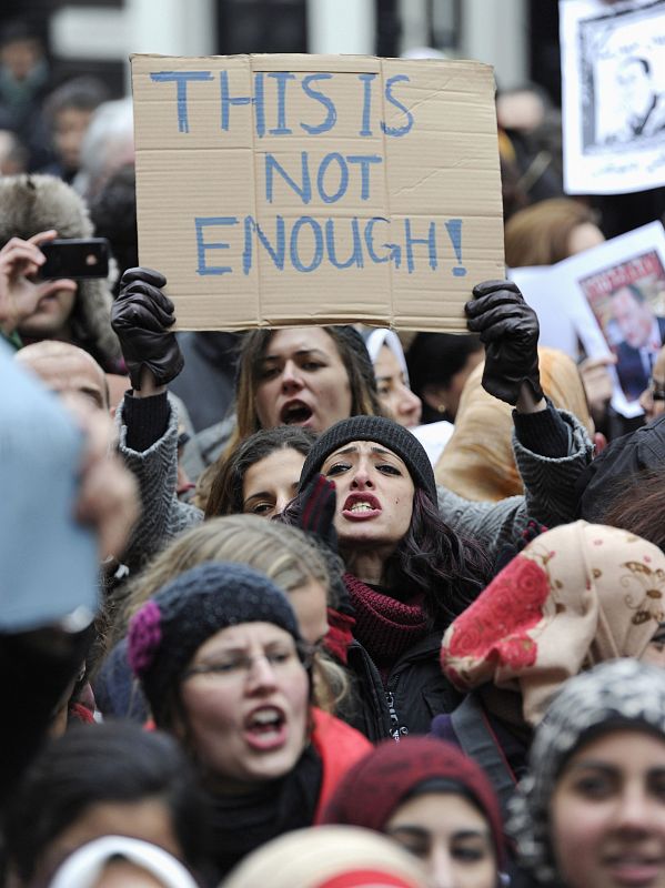 A demonstrator holds a placard during a protest at the Egyptian embassy in London