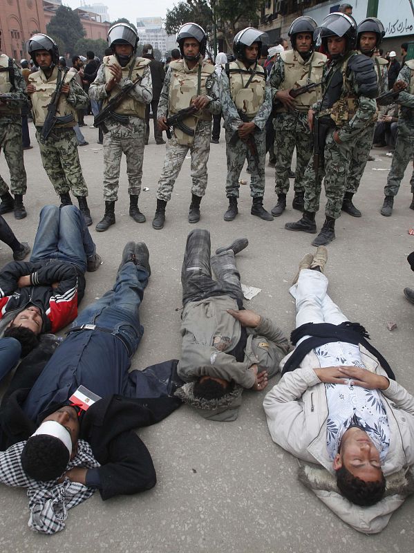 Opposition demonstrators lay in front of soldiers near Tahrir Square in Cairo