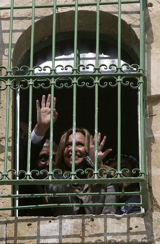 Trinidad Jiménez mira a través de una ventana enrejada en el casco viejo de Hebrón