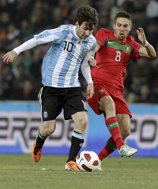 Argentina's Messi  fights for the ball with Portugal's Moutinho during their international friendly soccer match at the Stade de Geneve in Geneva