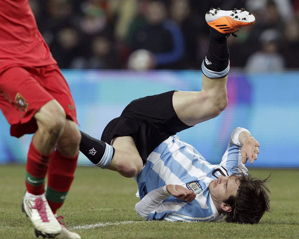Argentina's Messi falls during their international friendly soccer match against Portugal at the Stade de Geneve in Geneva