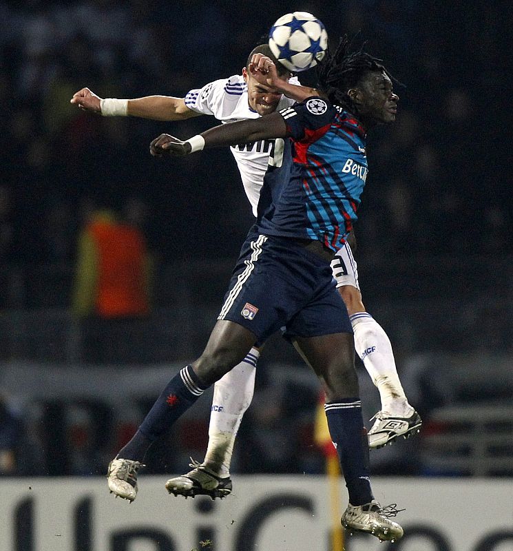 Olympique Lyon's Gomis challenges Real Madrid's Pepe during their Champions League soccer match in Lyon