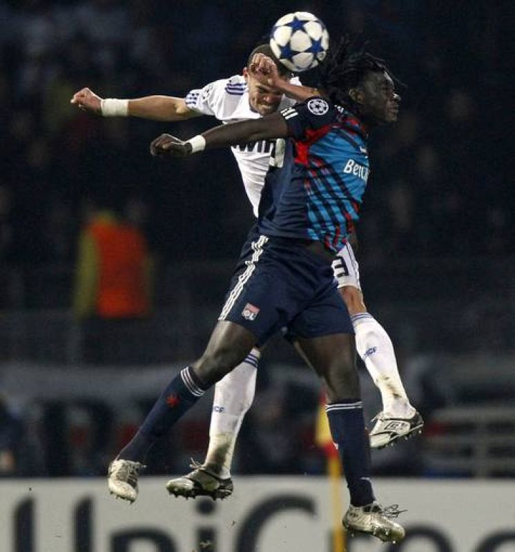 Olympique Lyon's Gomis challenges Real Madrid's Pepe during their Champions League soccer match in Lyon