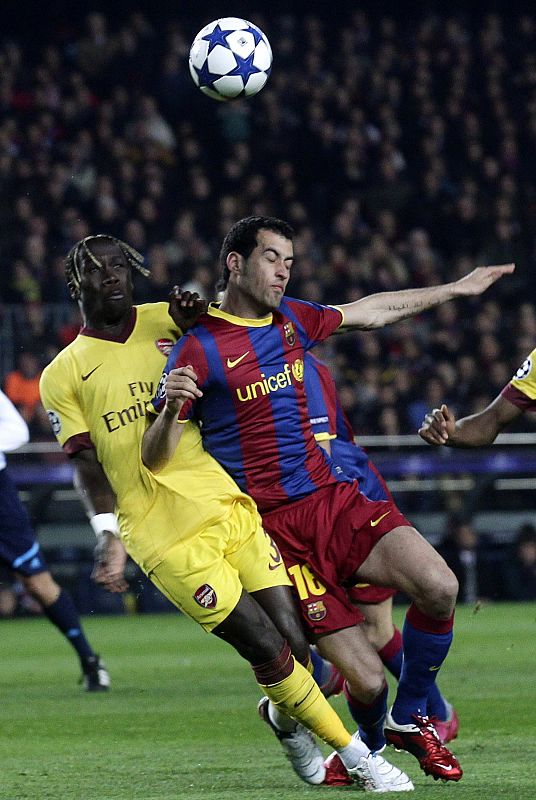 Barcelona's Pedro fights for the ball with Arsenal's Sagna during their Champions League soccer match in Barcelona