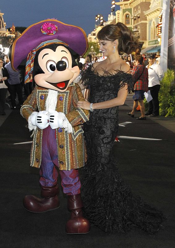Penelope Cruz poses with Disney character Mickey Mouse at the premiere of Pirates of the Caribbean: On Stranger Tides at Disneyland in Anaheim