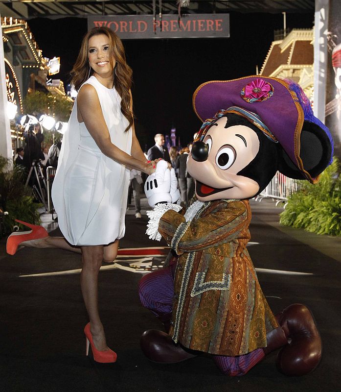 Eva Longoria poses with Disney character Mickey Mouse at the premiere of Pirates of the Caribbean: On Stranger Tides at Disneyland in Anaheim